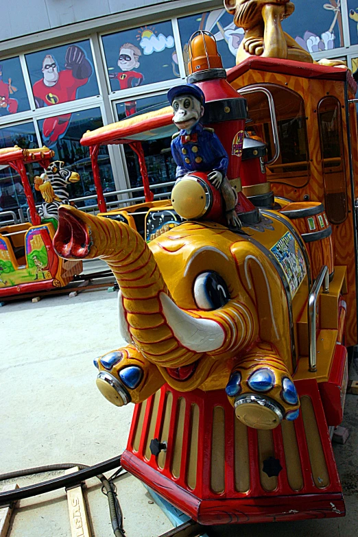 a toy elephant riding in the front of a train