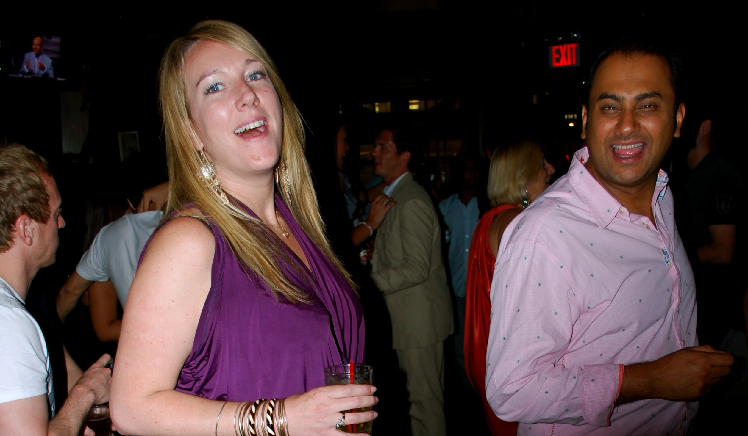 a woman with long hair is posing in a crowd