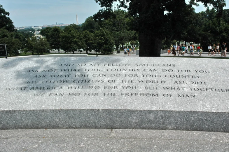 memorial stone with hand written message to people gathered around it