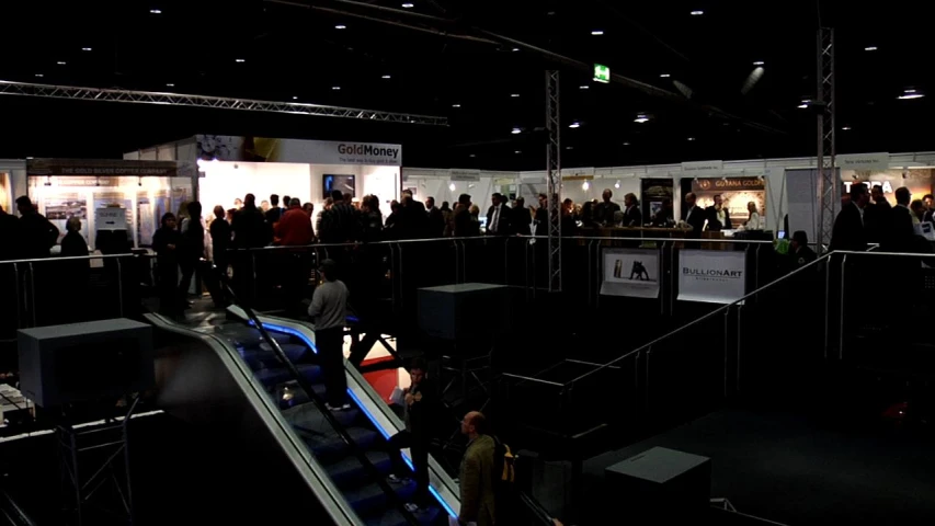 a big group of people standing in a black room