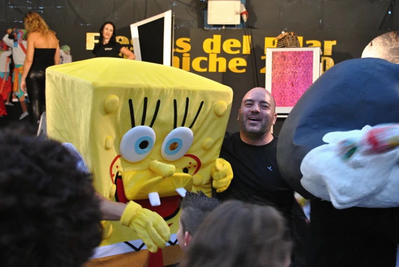 a man posing for a po in front of some characters