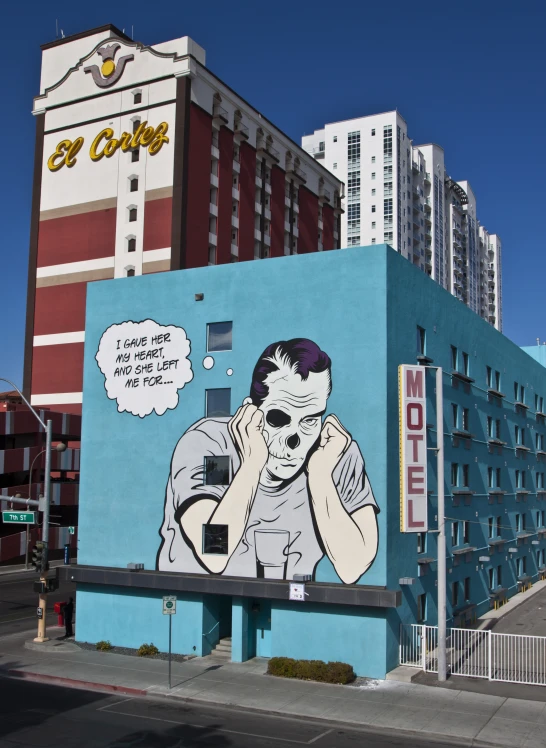a mural on the side of a building depicts a woman talking on her cell phone