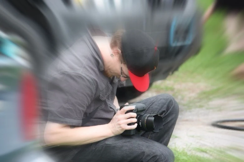 a man holding a camera taking a pograph