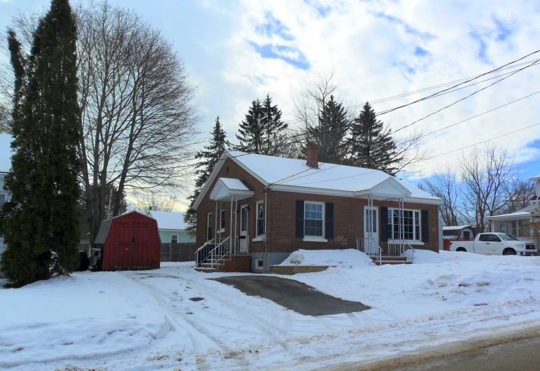 a house with snow on the ground in the front yard