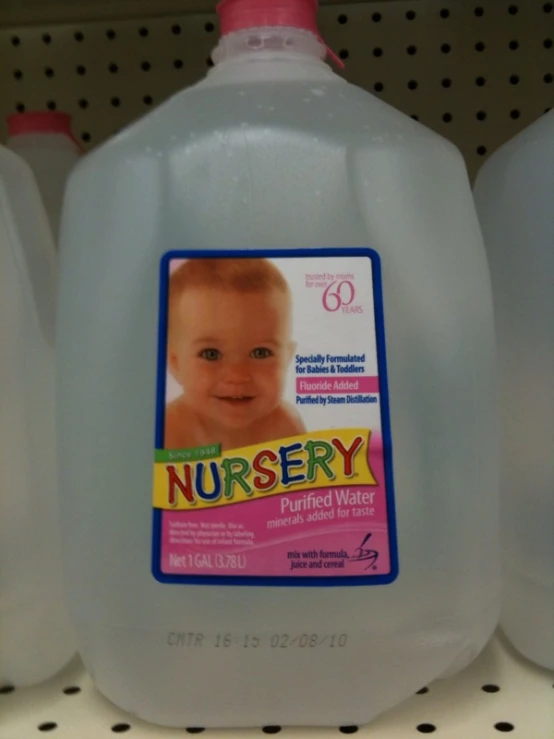 two plastic bottles of baby formulas and a baby bottle with no labels on them