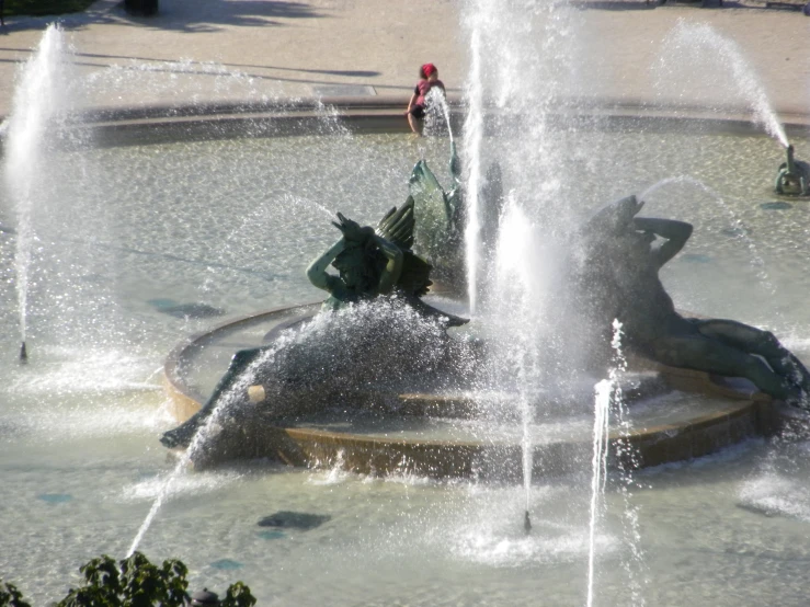 a statue on a fountain in a city