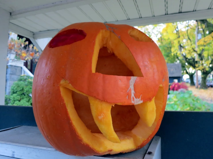 a carved pumpkin sitting on a shelf near other items