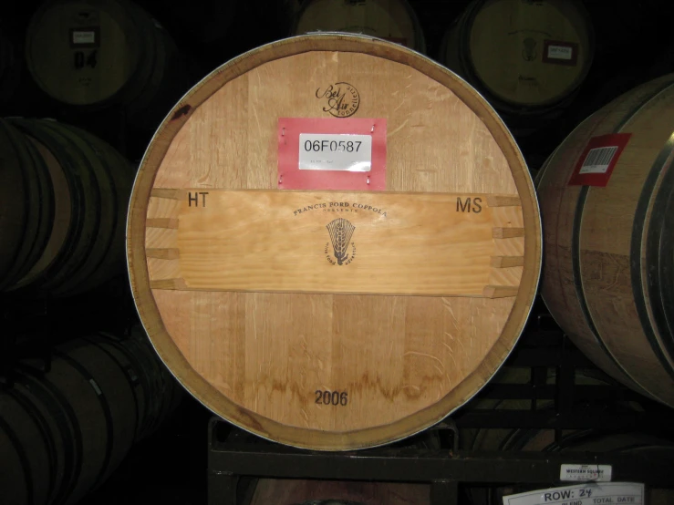 a barrel in a wooden storage area next to many barrels