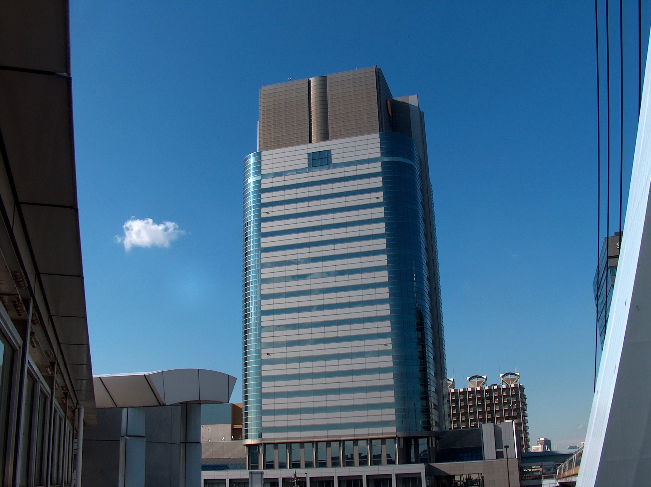 a building stands tall above buildings and city streets