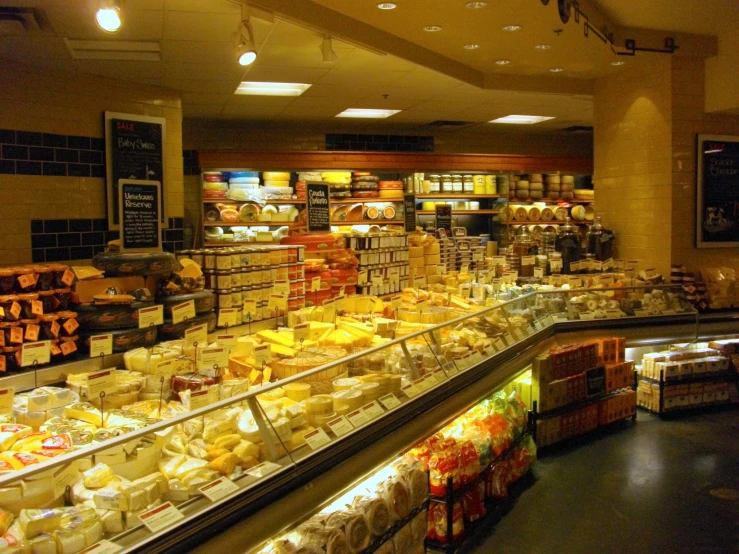 a store filled with lots of shelves covered in cheese