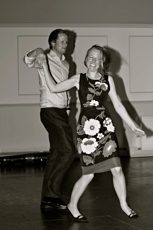 a couple standing next to each other on a dance floor