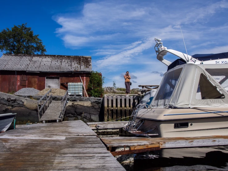 a boat tied to the dock by a house