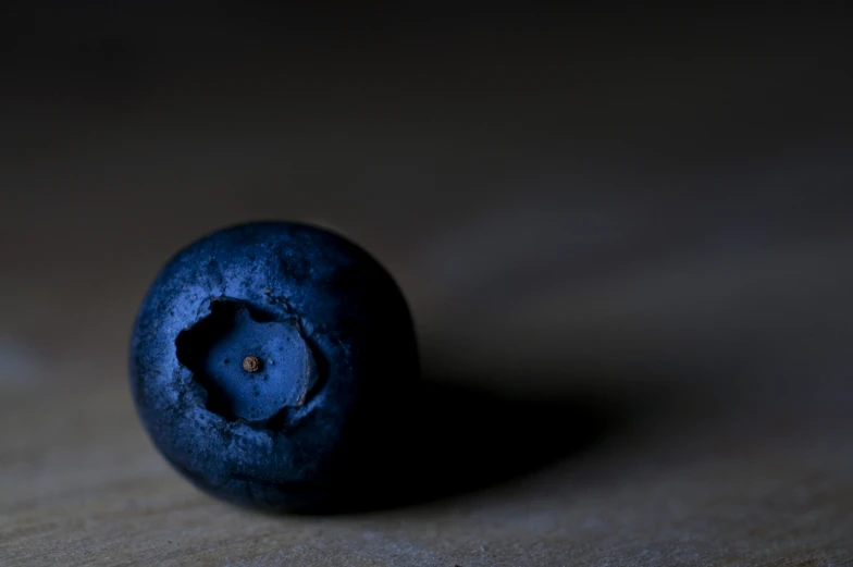 a rotten piece of blueberries sitting on top of a table