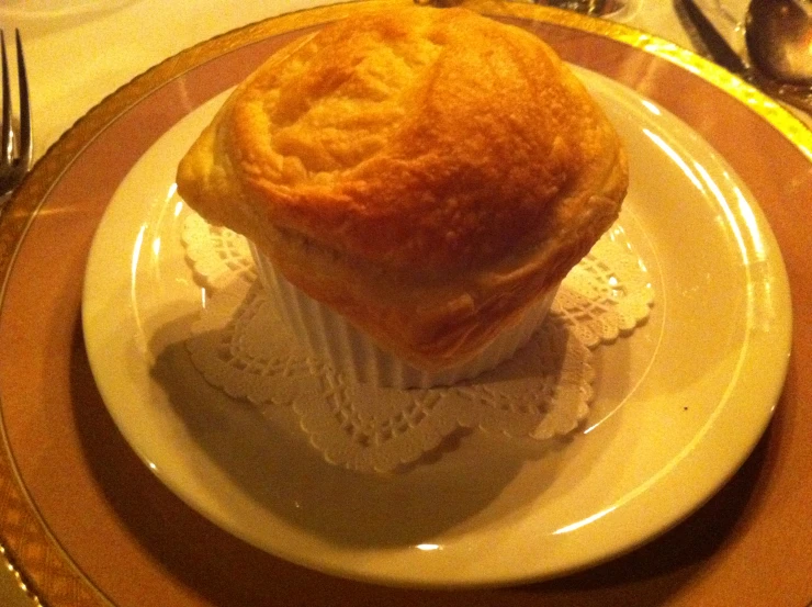 an empty croissant sits atop a small plate