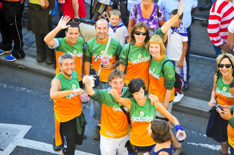 people wearing orange and green are posing for the camera