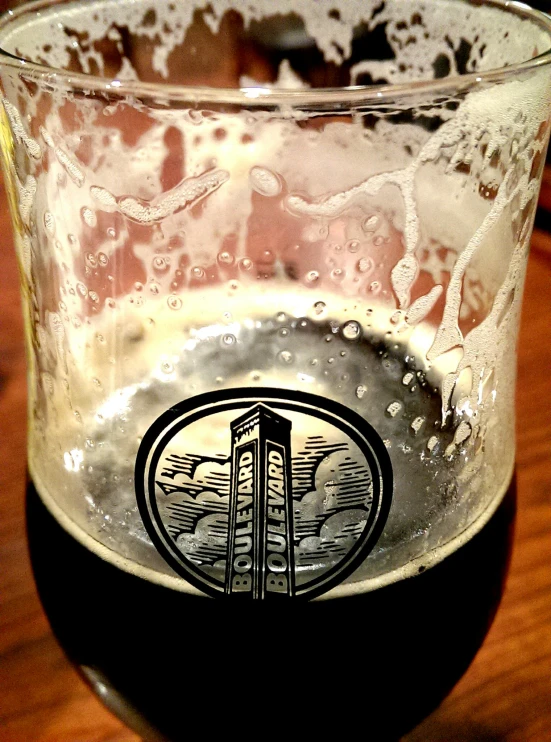 an empty glass sitting on top of a wooden table