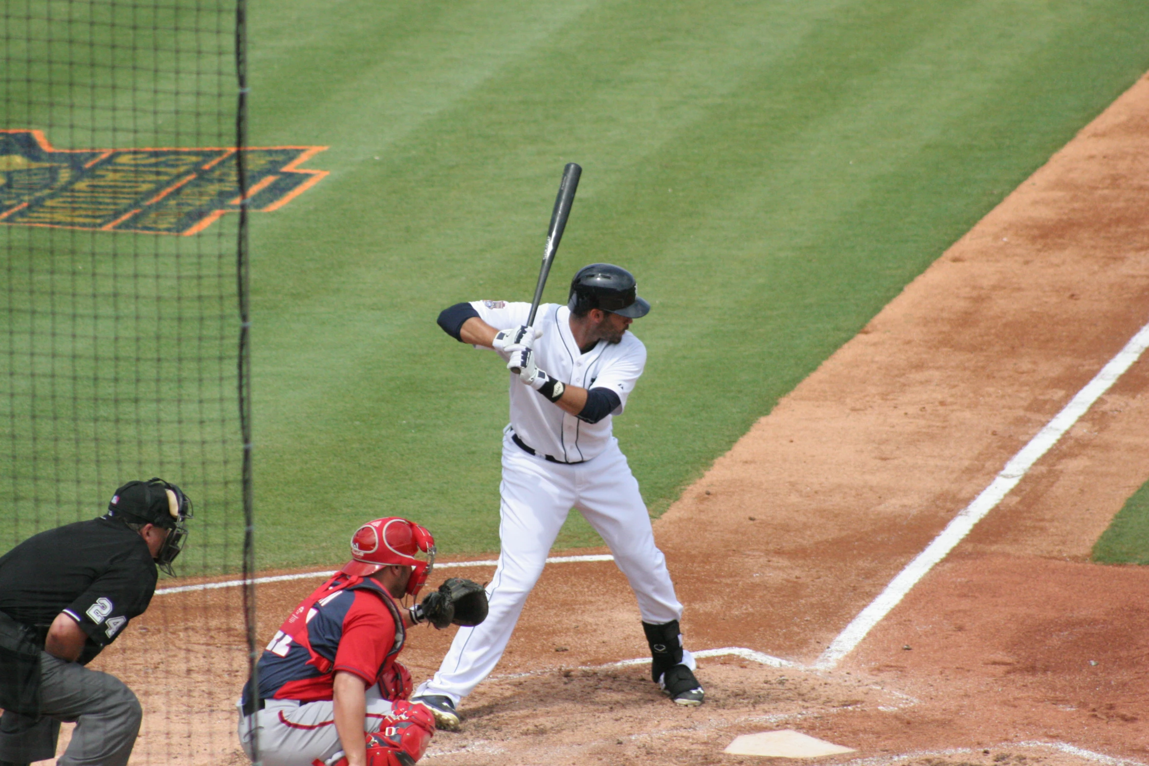 the base ball player is taking his swing at a ball