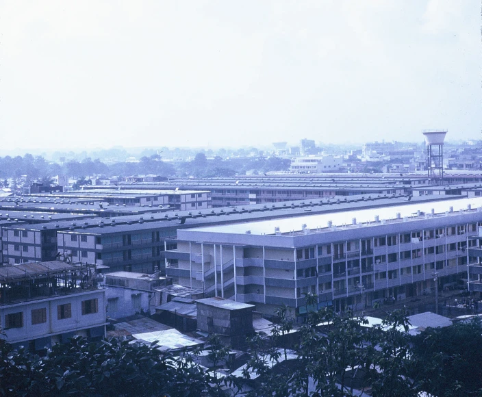 a tall building with some windows near trees and buildings