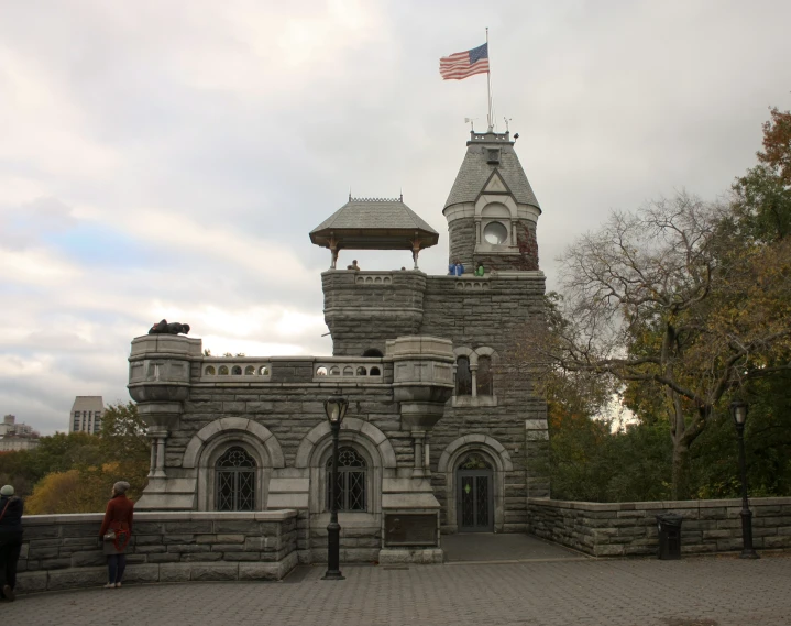 a stone castle is shown against a cloudy sky