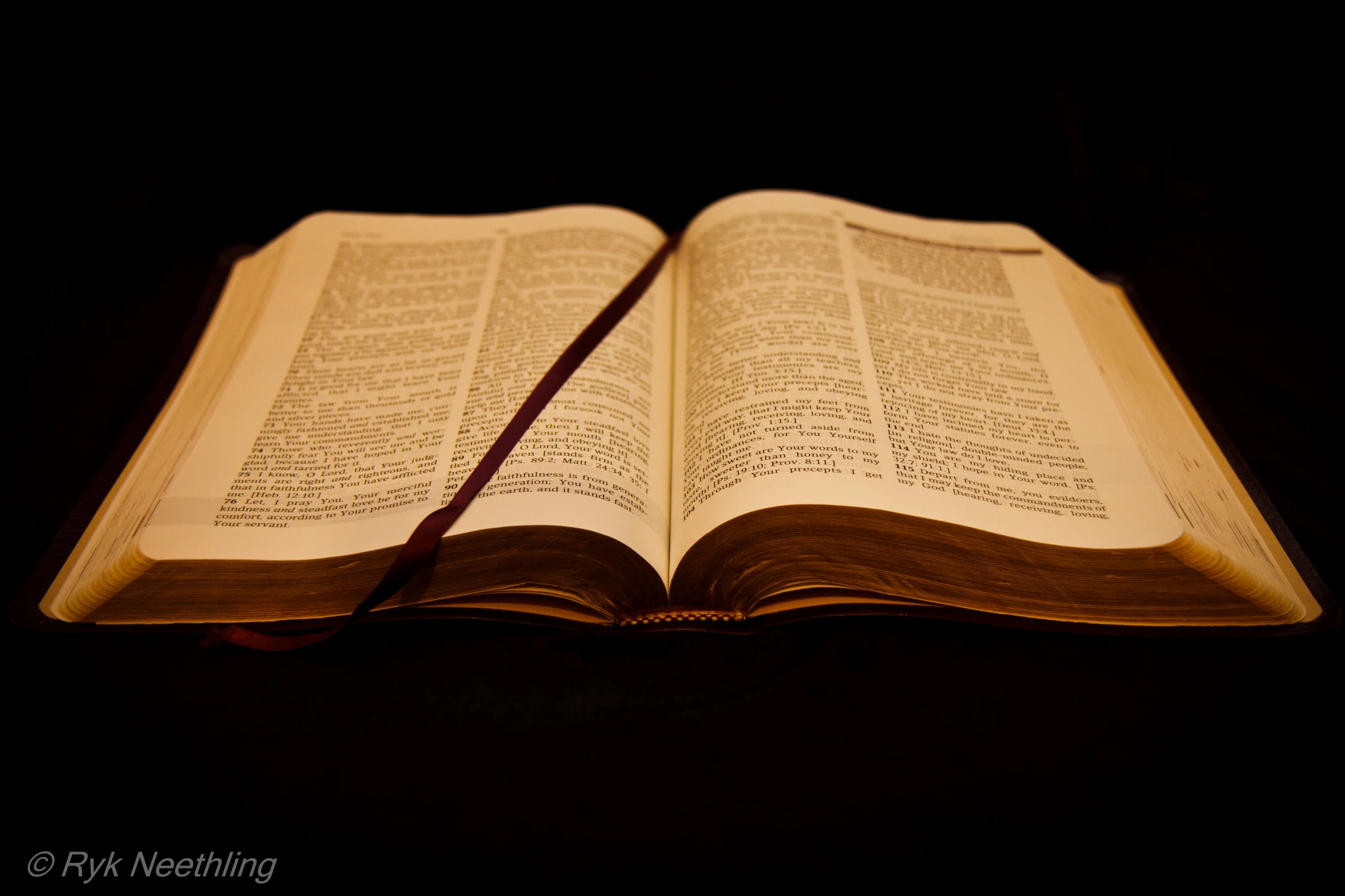 an open bible laying on top of a table