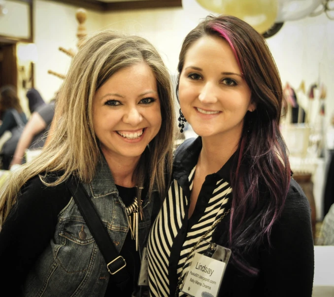 two ladies smile for the camera in a salon