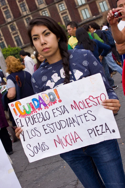 a girl holds a sign at a protest