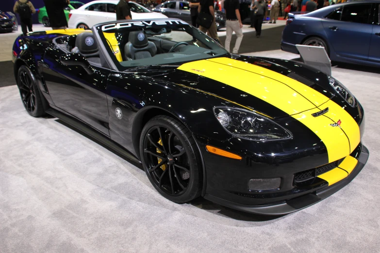 a black and yellow sports car sitting on display