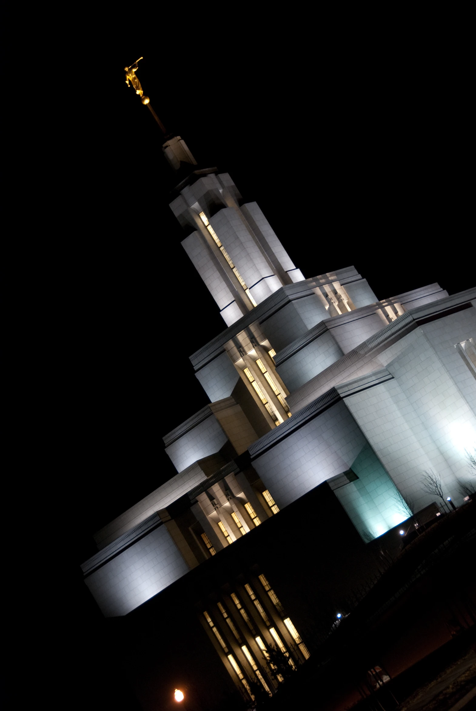 an architectural structure lit up at night with a clock