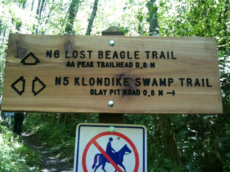 a sign for hiking trail, next to trail sign