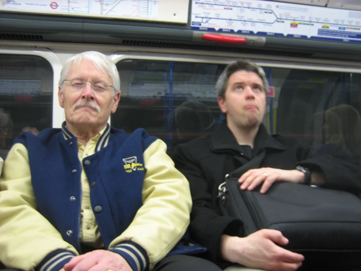 a man and a woman are riding the subway