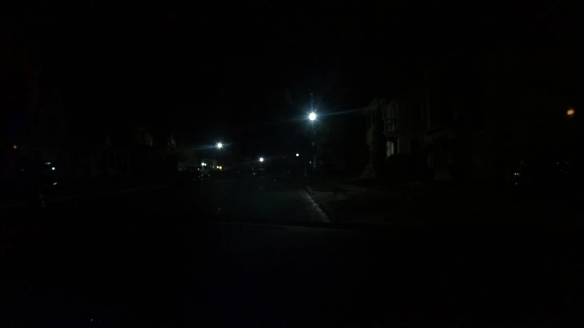 night time picture of street lamps and a dark road