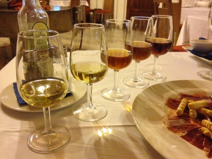 wine glasses sit on top of a white table