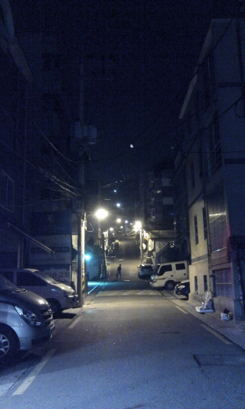 the dark night time street is empty of people