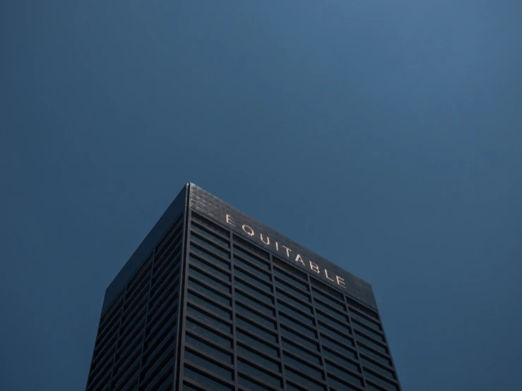 an airplane flying past the top of a tall building