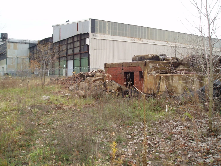 an old rusted out building sitting in front of it's outside