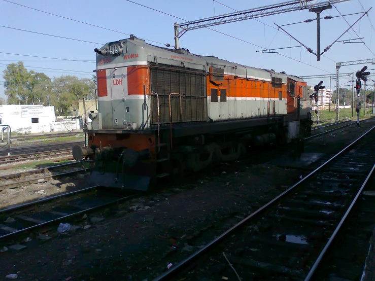 train on tracks in rural area with utility tower in the background