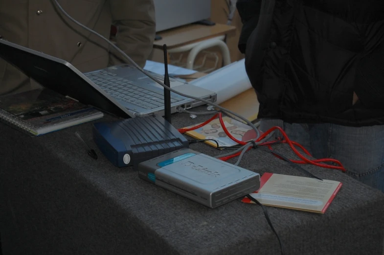 a laptop and a book sitting on a table