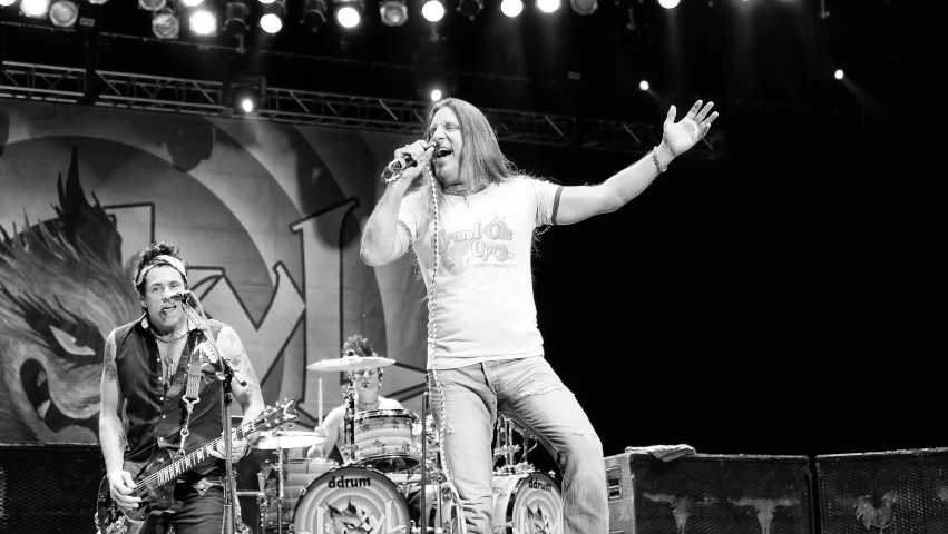 two men singing at an outdoor music event