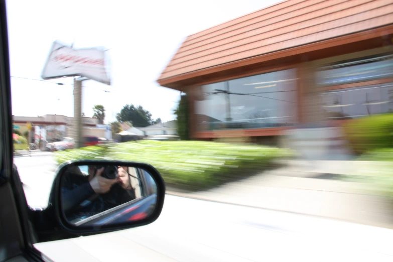 the side view mirror on a car of a building