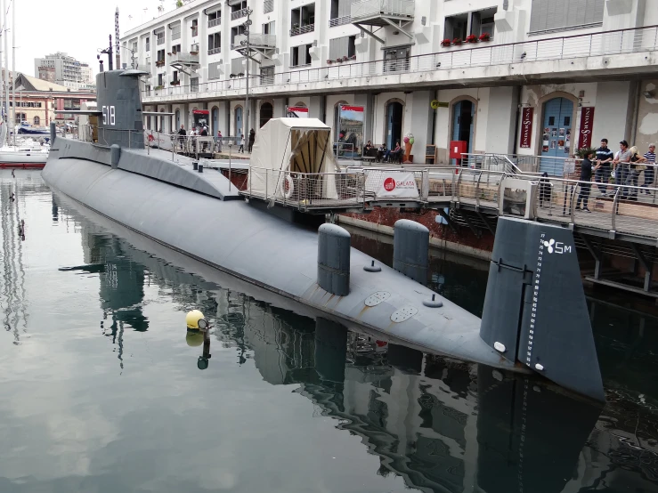 a submarine in a river near some buildings