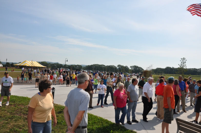 a group of people standing on top of a cement road