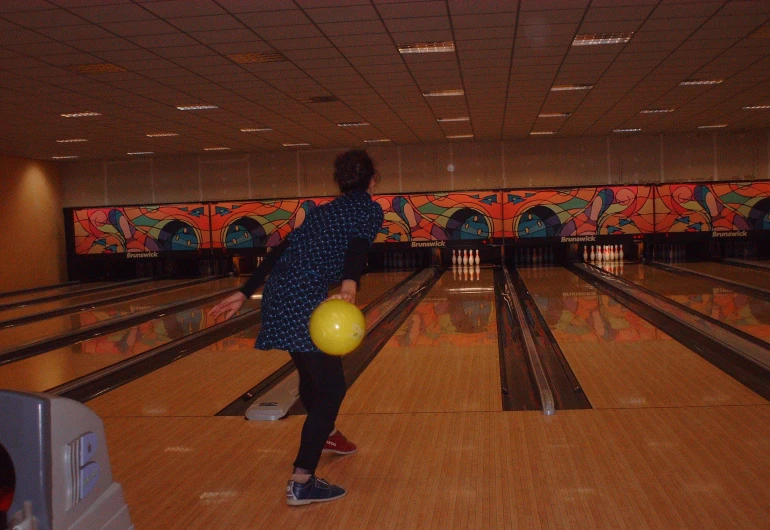 a man is holding a ball and throwing it