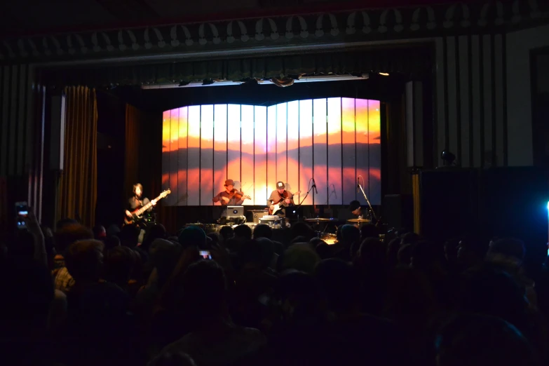 some people are standing on stage with instruments