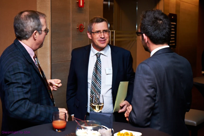 four men are having conversation while standing together