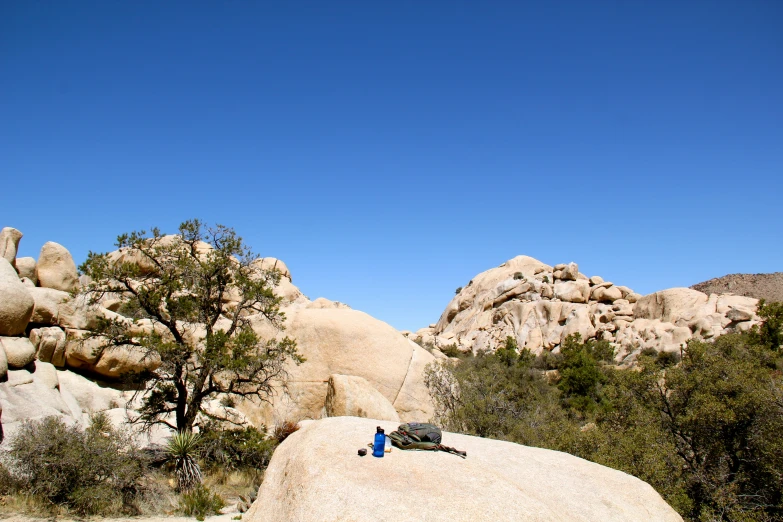 the man is resting on the rock in the wilderness