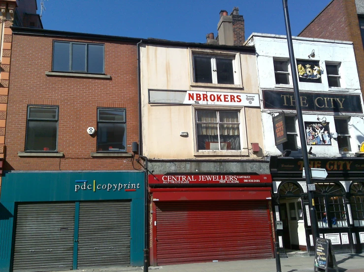 the street corner has several stores and brick buildings