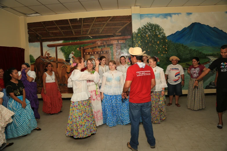 there is a man dancing next to some women