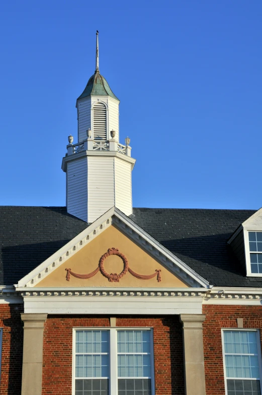 a church steeple and clock tower against a blue sky