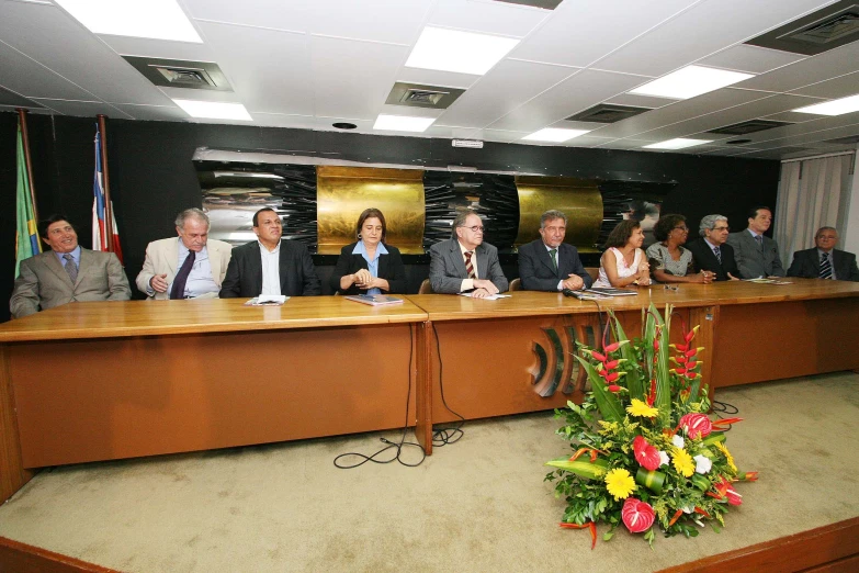 a group of people are sitting at a meeting