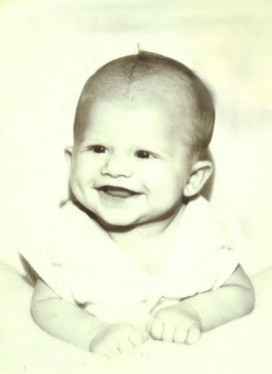 a baby laying down in a white blanket